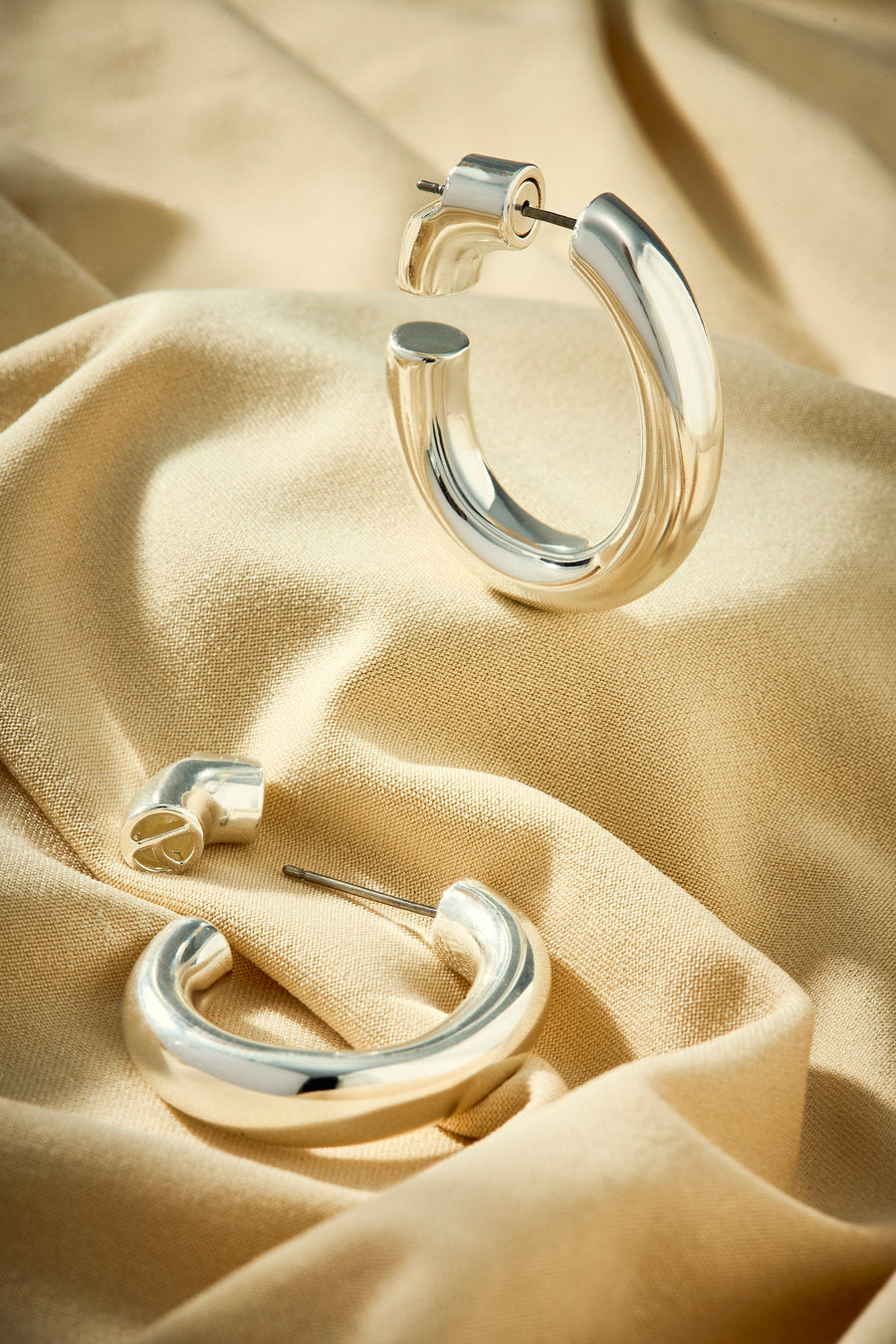 Women's silver hoop earrings with soft curves and minimalist elegance.