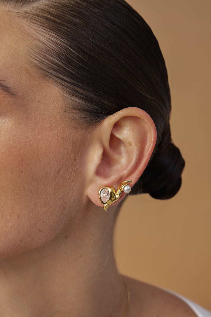 Gold-tone Audrey earring with a faceted crystal, pearl, and organic design.
