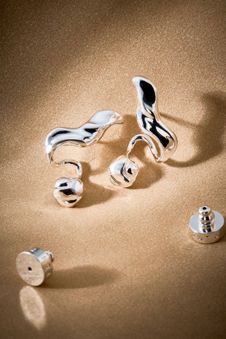 Pair of silver Frida earrings featuring an organic design, sculptural volume, and a polished finish.
