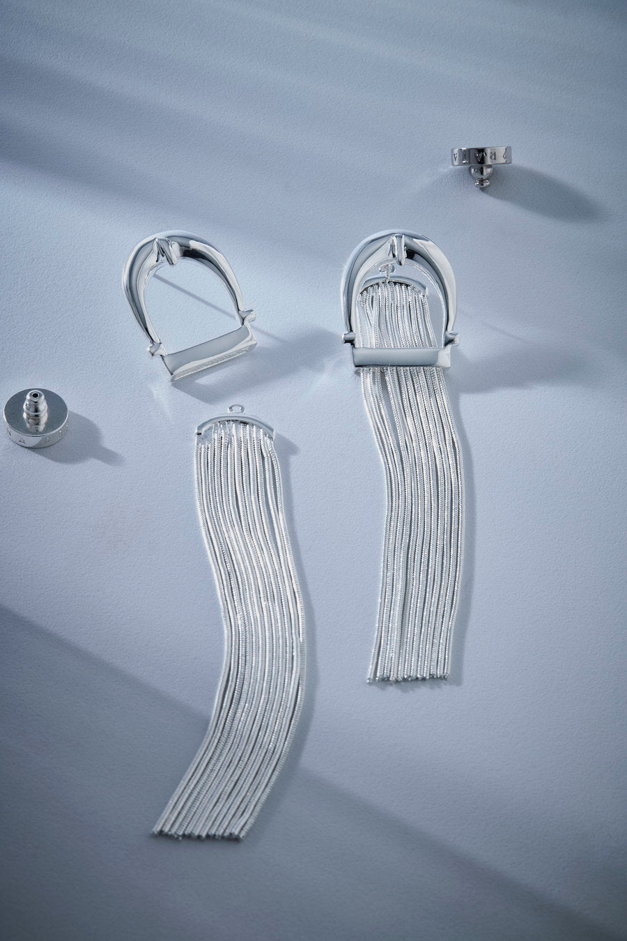 Silver earrings, long earrings, fringe earrings, chain earrings, statement earrings, sculptural earrings, party earrings, sophisticated earrings, elegant earrings, gold jewelry, modern earrings, impactful earrings, fashion accessory, designer earrings, contemporary jewelry