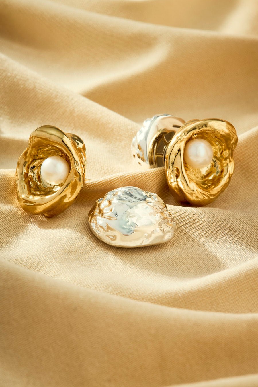 Achado silver and gold earring with pearl in a shell and contemporary design.