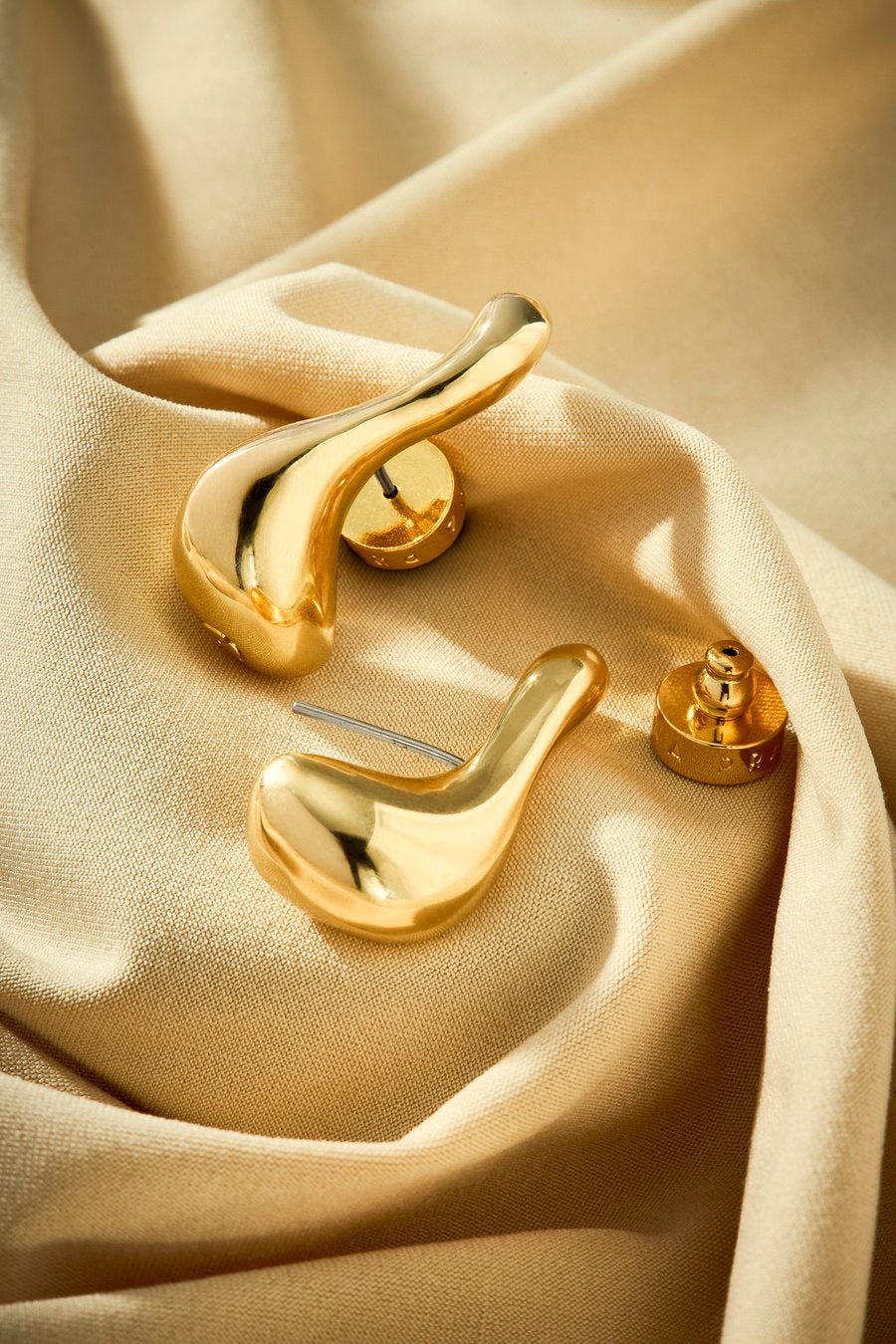 Contemporary gold earrings with flowing lines and an elegant look.