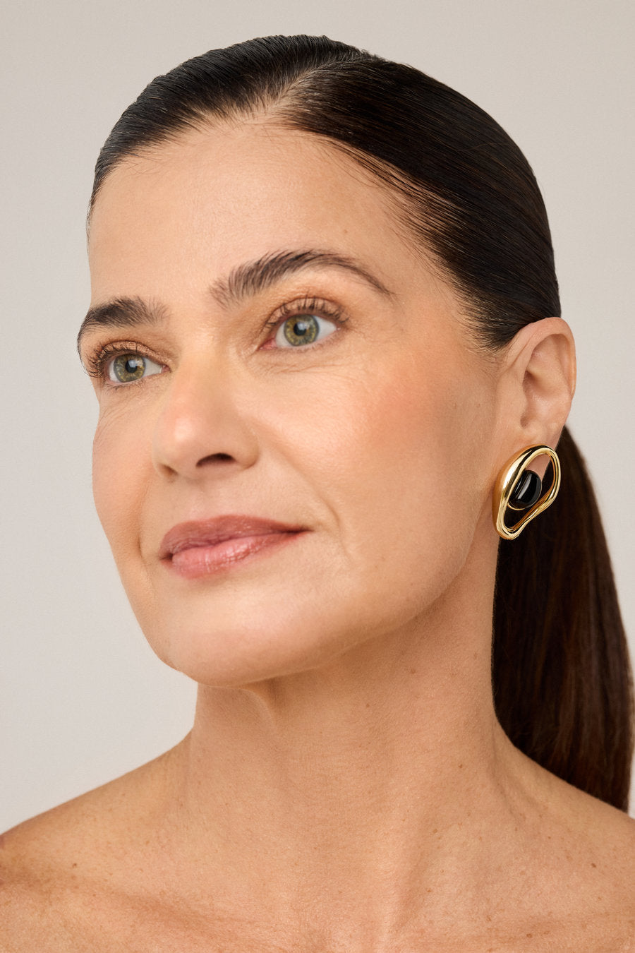Designer silver earring with crystal and a modern, elegant look.