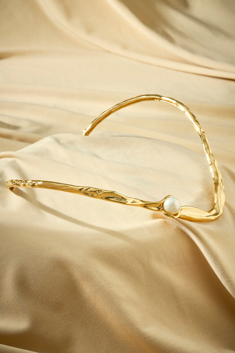 Women's gold choker with pearl and open, organic, flowing design.