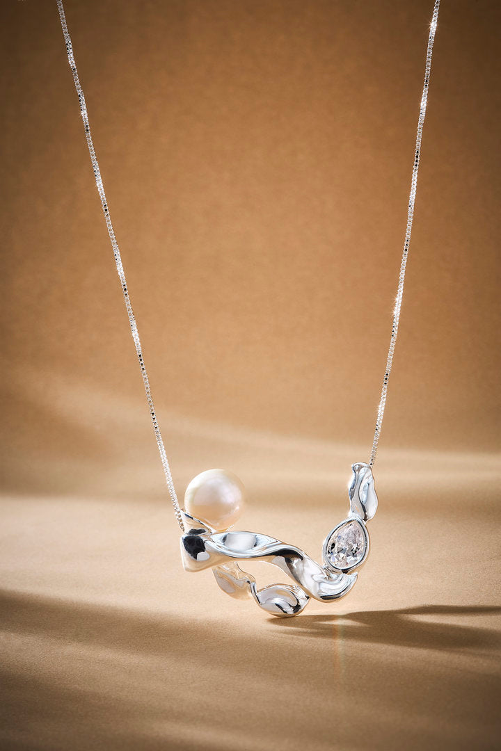Audrey silver necklace with a delicate chain, pearl, and Austrian crystal.
