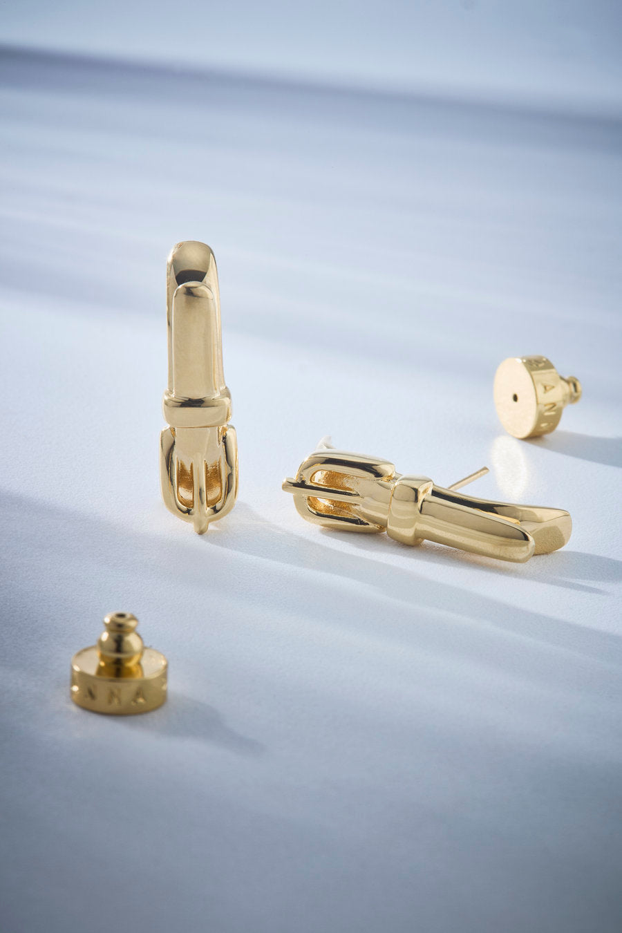 Gold earhook, earhook earring, modern gold earring, sculptural earring, original earring, contemporary earring, sophisticated earring, designer earring, statement earring, gold jewelry, elegant earring, gold ear cuff, modern women's accessory, minimalist earring, contemporary jewelry