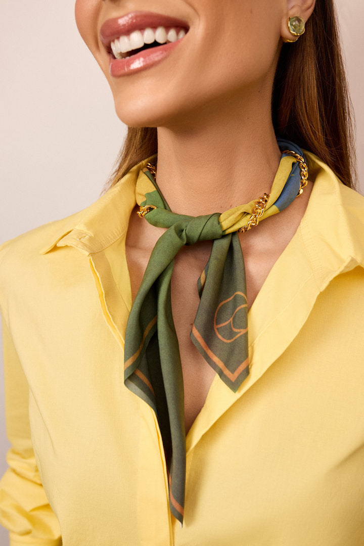 Green scarf with artistic Brazil-inspired design, ideal for football, travel and cultural events.