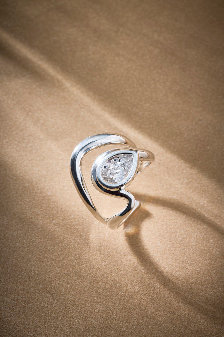 Audrey ring in silver with a central crystal and organic structure.

