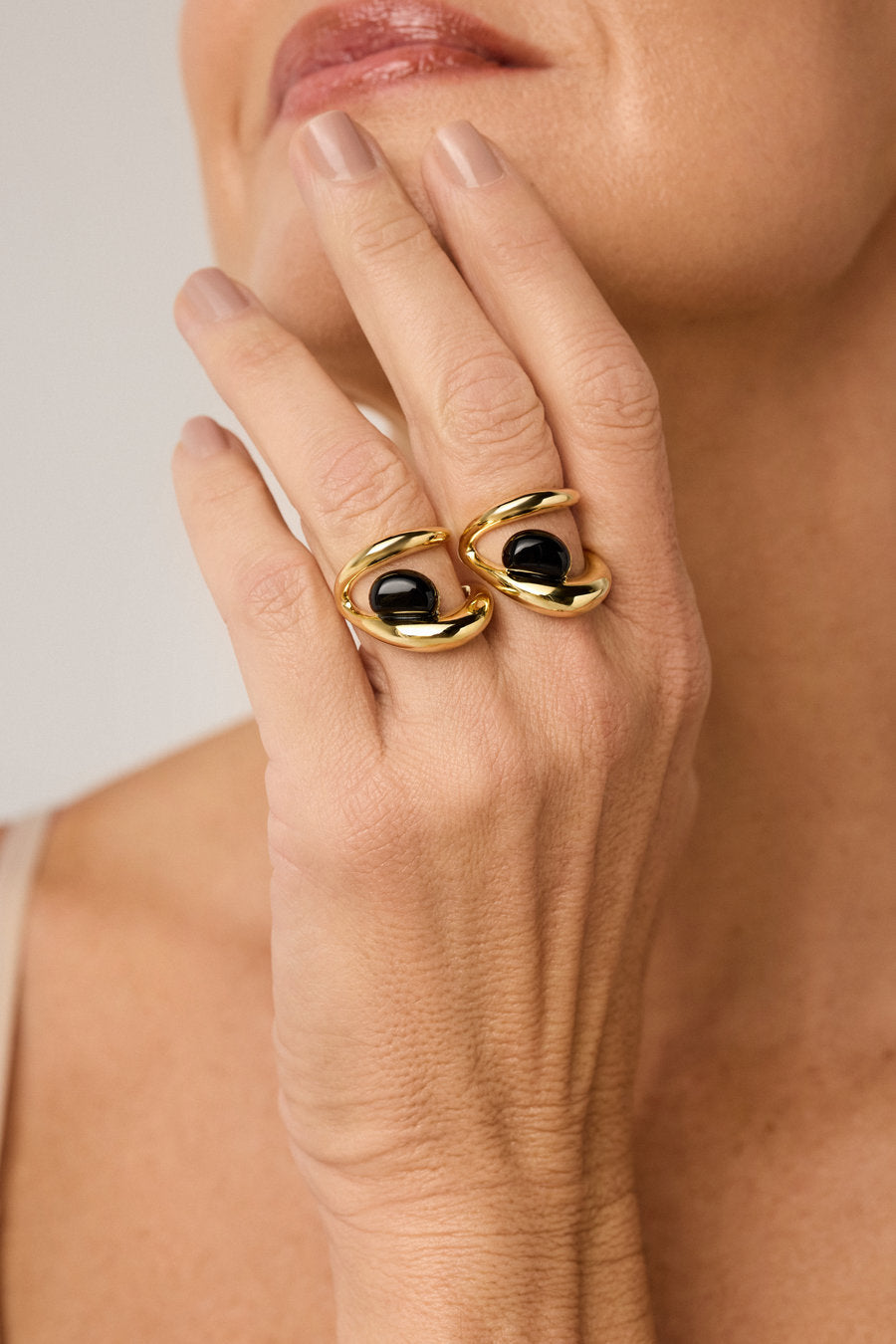 Gold-plated gift ring with onyx and sculptural organic design.
