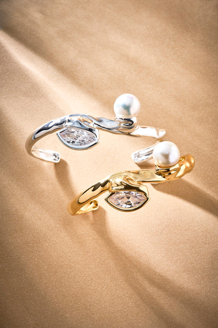 Gold and silver Gabrielle bracelet featuring organic curves, a pearl, and an Austrian crystal.