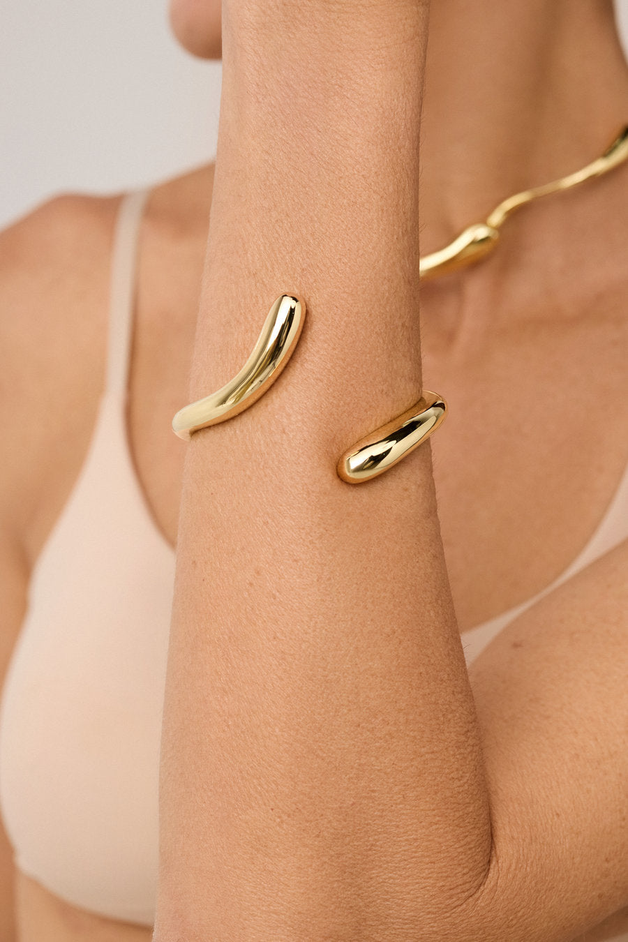 Gold Memory Bracelet with a fluid organic design and open shape.
