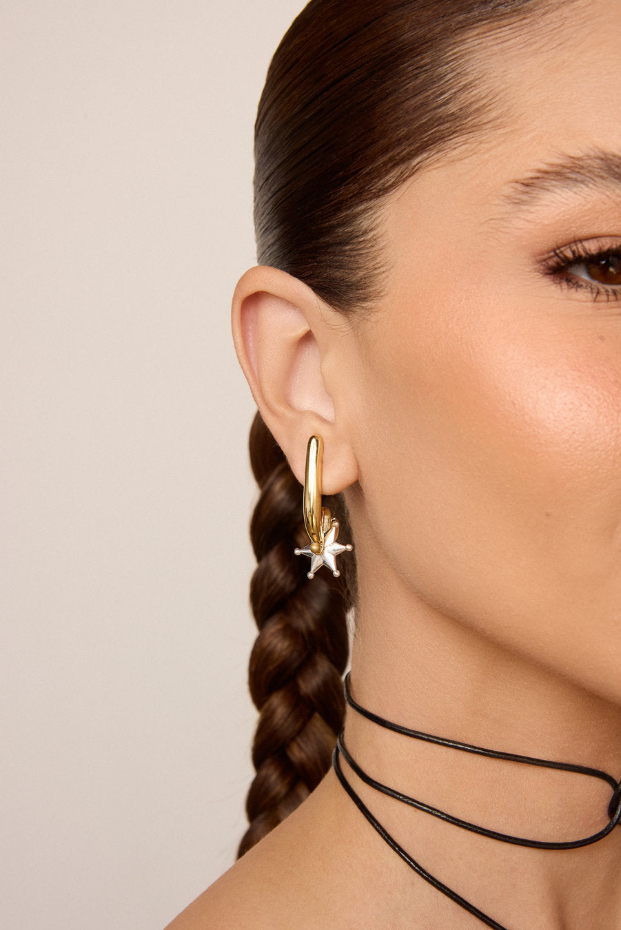 Gold earrings, sculptural earrings, statement earrings, star earrings, two-tone earrings, modern earrings, impactful earrings, sophisticated earrings, gold jewelry, designer earrings, fashion earrings, elegant earrings, statement accessory, party earrings, contemporary jewelry