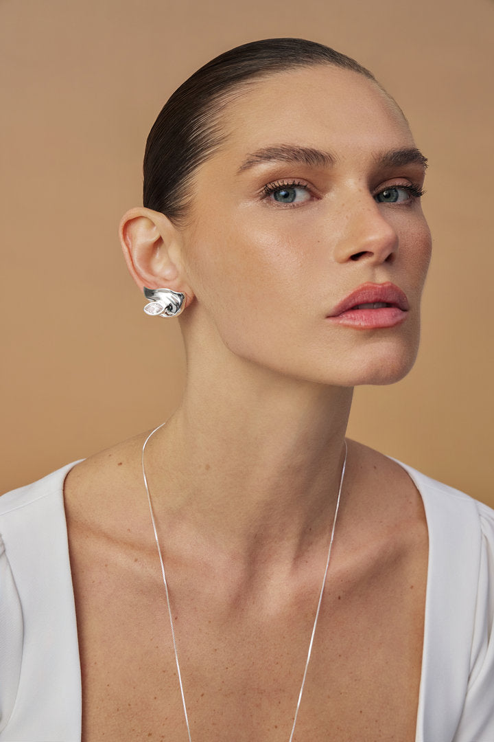 Elsa earring featuring Austrian crystal and fluid shapes —  a statement piece for sophisticated looks.
