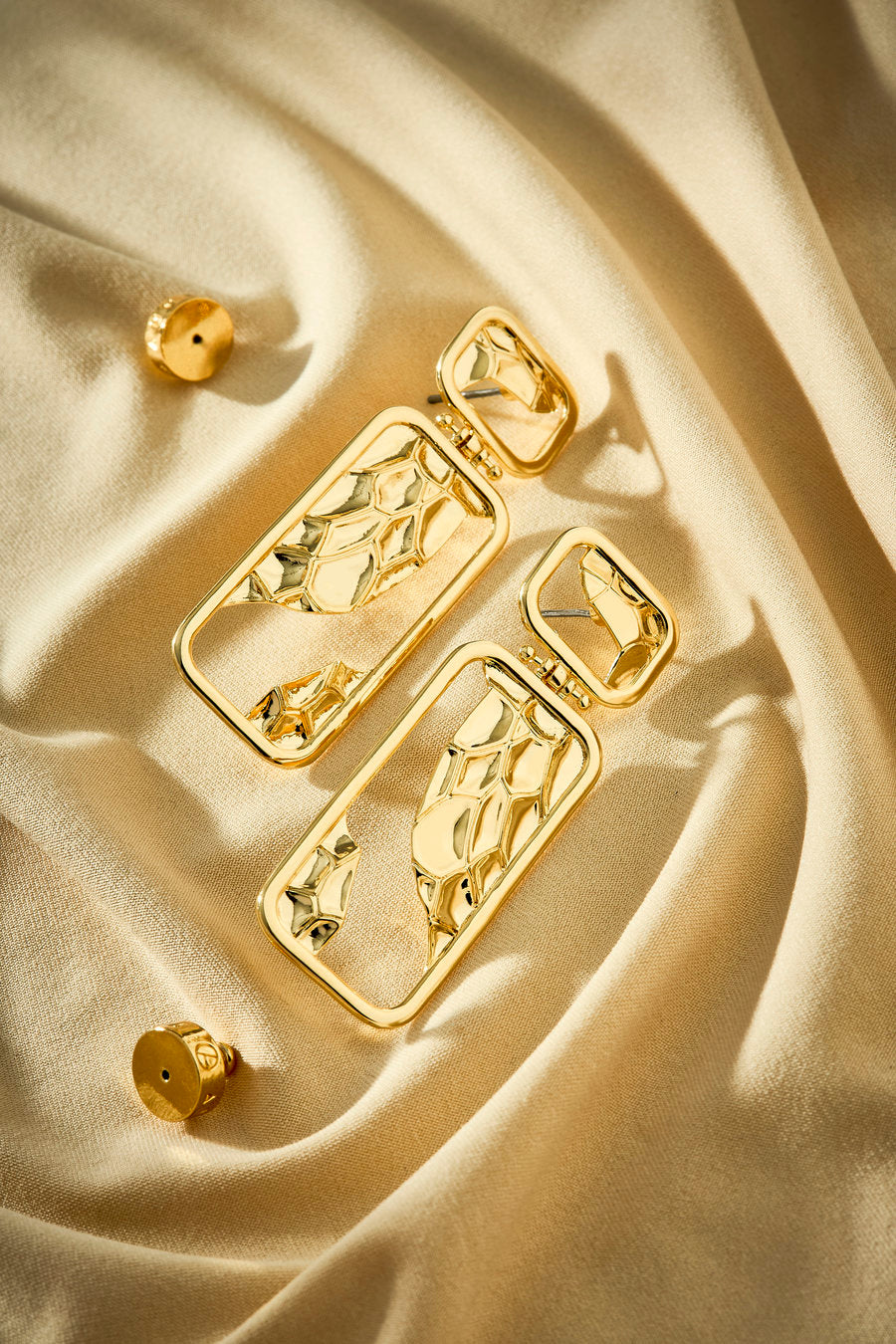 Gold Era earring with sculptural geometric design and openwork cutout.
