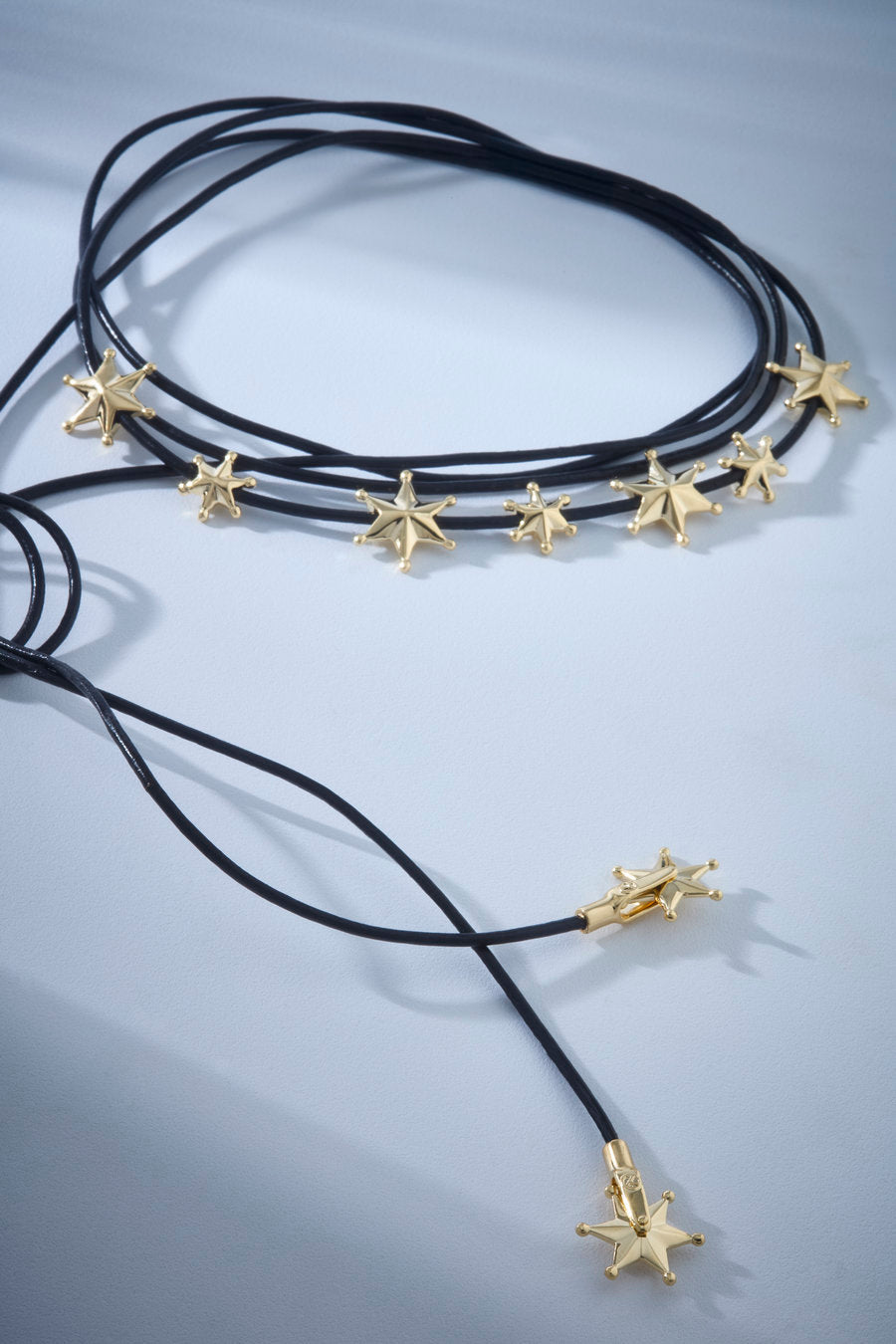 The Authority necklace, featuring a brown cord and silver stars, is a modern and striking accessory for looks full of personality.
