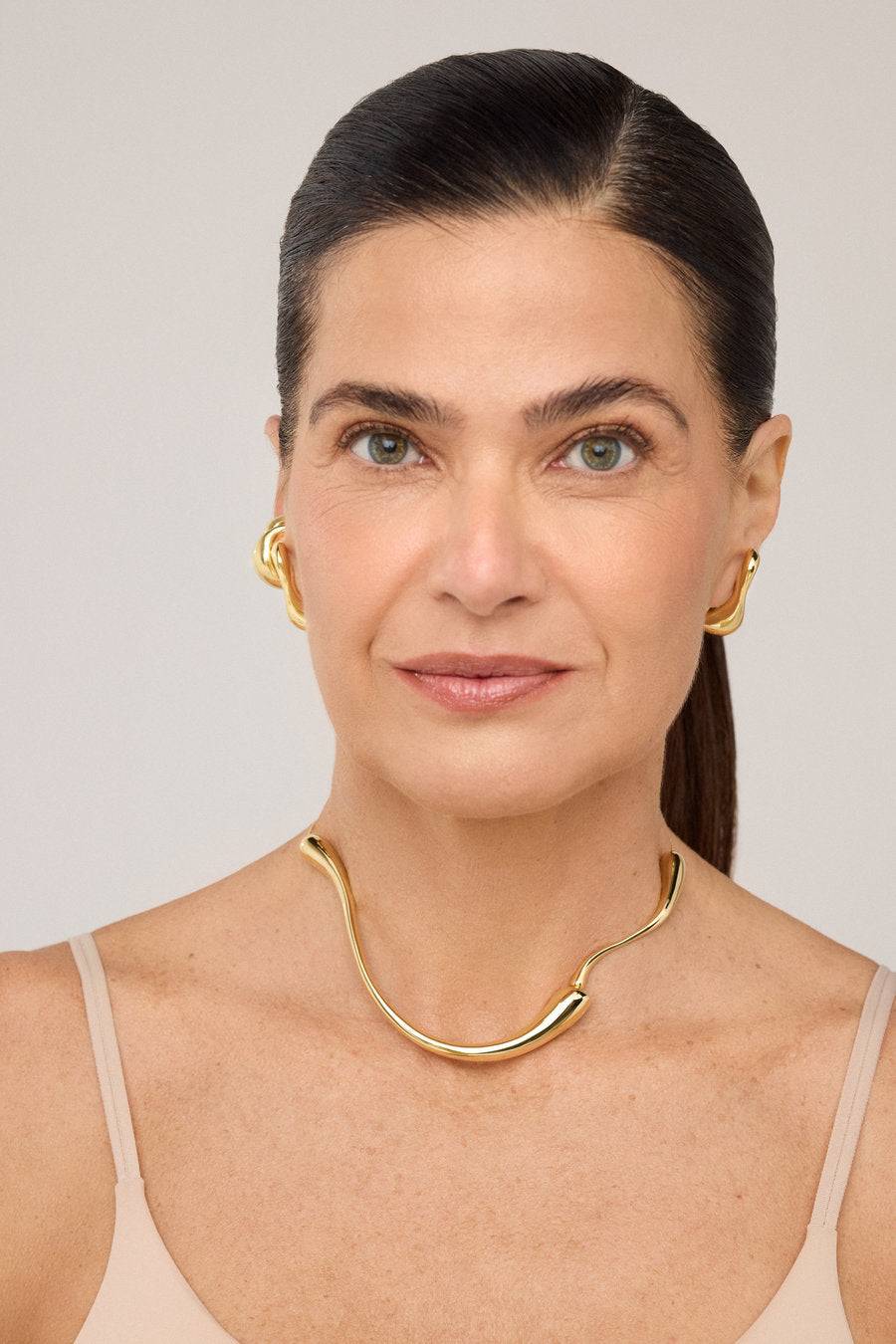 Gold Memory choker with a fluid organic design and open shape.
