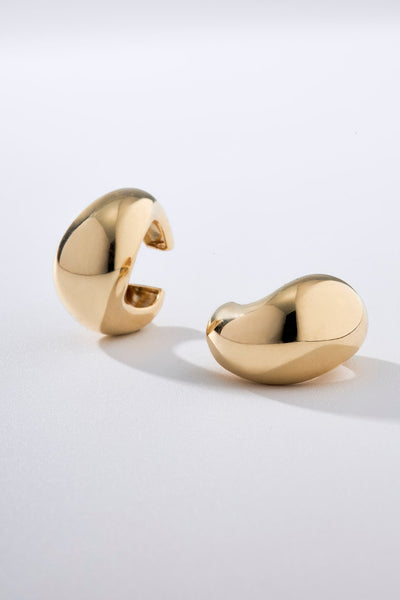 gold piercing, women's piercing, clip-on piercing, organic-style piercing, sculptural piercing, teardrop piercing, modern piercing, gold piercing, sophisticated piercing, silver ear cuff, designer piercing, gold jewelry, elegant piercing, gift-worthy piercing