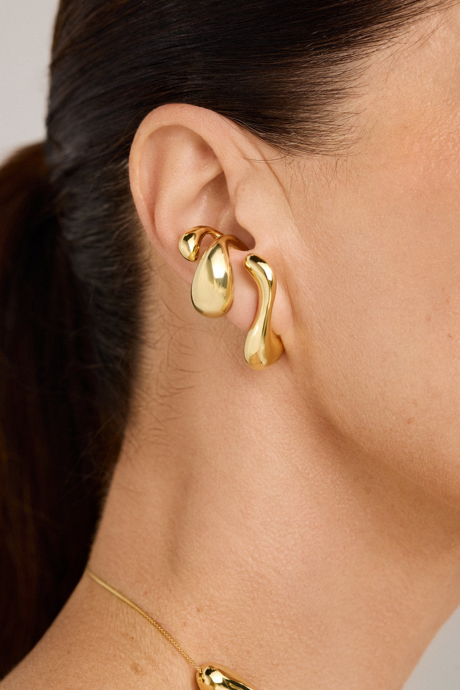 Gold Memory Piercing with organic sculptural design and fluid curves.
