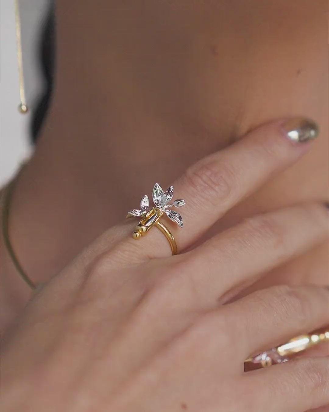 Gold and silver Plenitude ring – floral design featuring leaves and petals in a sculptural composition.
