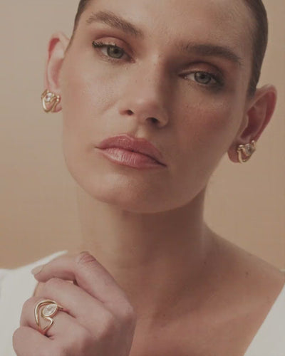 Small gold and white gold Audrey earring, featuring an Austrian crystal cradled by delicate curves of timeless beauty.
